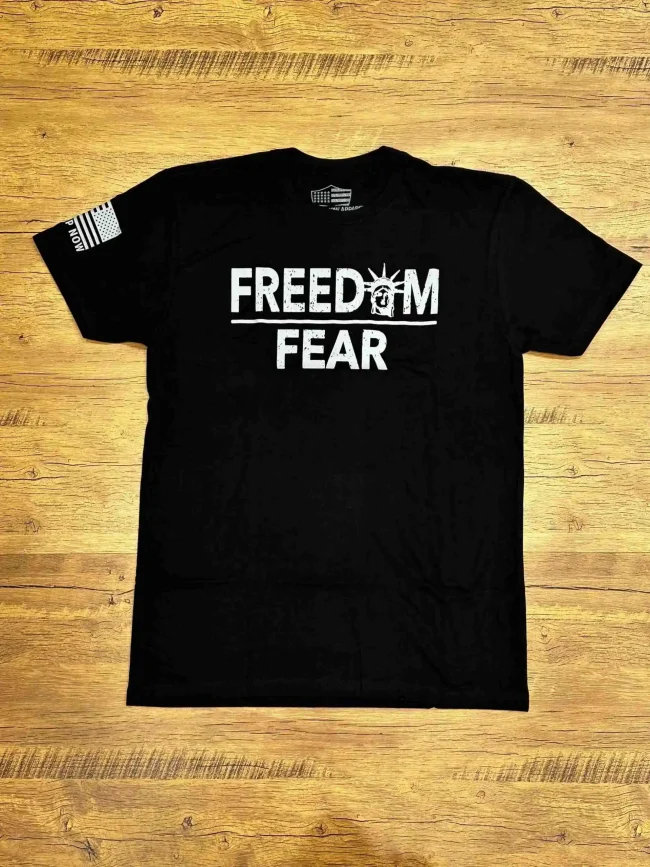 Stand Up Boldly and show your American patriotism in this comfortable shirt. FREEDOM over FEAR is the perfect expression of what a patriotic shirt should be. 1776 betsy ross flag on the back. Shirt comes in black, sand, grey & green